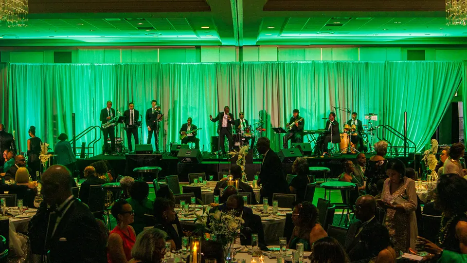 Full jazz band performing onstage for The Moles Conclave 2026 with the ballroom audience in view