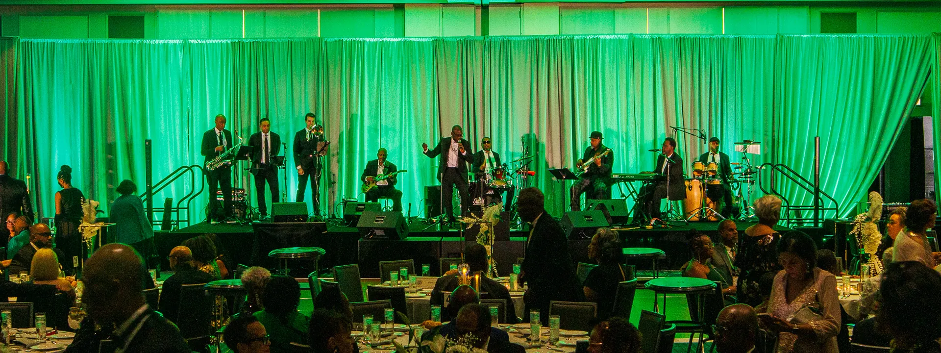 Full jazz band performing onstage for The Moles Conclave 2026 in a ballroom at Marriott Mag Mile